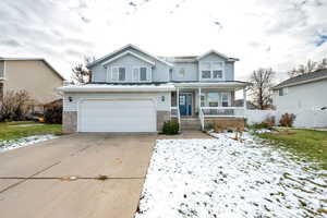 View of front property featuring a porch and a garage