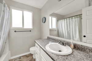 Upstairs full bathroom with shower / bath combo, vanity, and toilet