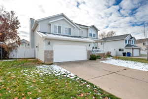 View of front property with a front yard and a garage