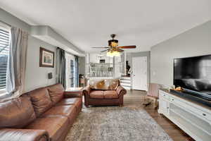 Living room featuring dark hardwood / wood-style floors and ceiling fan