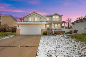 View of front property featuring a porch and a garage