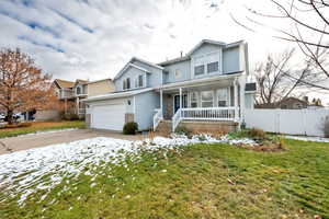 View of front property with a porch and a yard