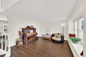 Sitting room with dark wood-type flooring