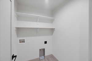 Laundry Room with hookup for an electric dryer, washer hookup, and light wood-type flooring