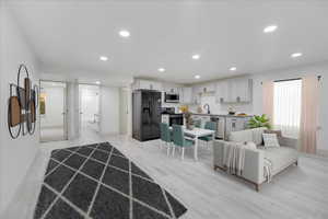 Living room featuring sink and light wood-type flooring