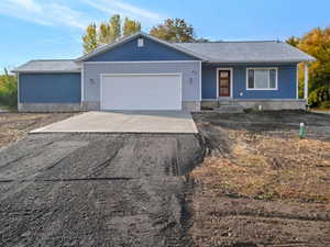 Ranch-style home featuring a garage