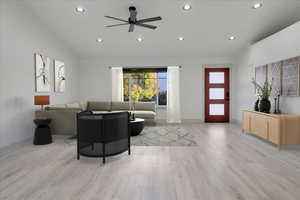 Living room with light hardwood / wood-style flooring, ceiling fan, and lofted ceiling