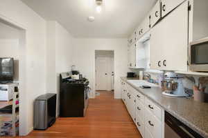 Kitchen featuring white cabinetry, sink, appliances with stainless steel finishes, and light hardwood / wood-style flooring