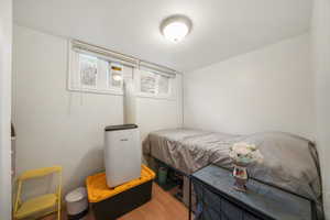 Bedroom with hardwood / wood-style flooring