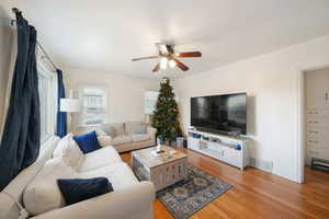 Living room featuring ceiling fan and hardwood / wood-style flooring