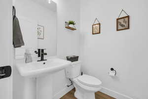 Bathroom with wood-type flooring and toilet