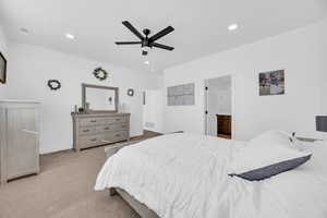 Carpeted bedroom with ceiling fan