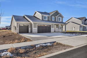 View of front of home featuring a porch and a garage