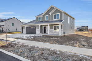 View of front of house with a porch and a garage