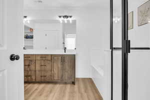 Bathroom featuring wood-type flooring and vanity