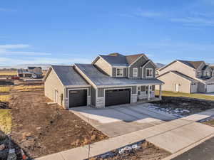 View of front of home featuring covered porch and a garage