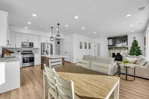 Dining area featuring sink and light hardwood / wood-style floors