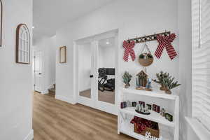 Hall with hardwood / wood-style floors