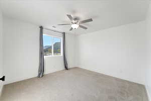 Unfurnished room with light carpet and ceiling fan