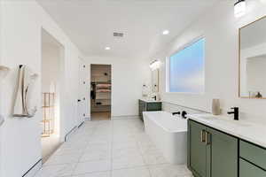 Bathroom featuring vanity and a tub