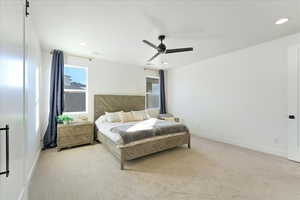 Bedroom featuring ceiling fan and light colored carpet