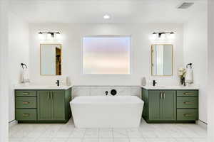 Bathroom with a washtub and vanity