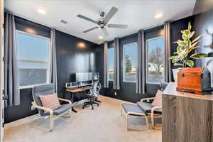 Carpeted office with ceiling fan