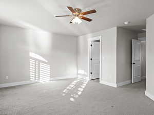 Empty room with light carpet and ceiling fan