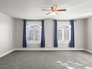 Unfurnished room featuring carpet flooring and ceiling fan