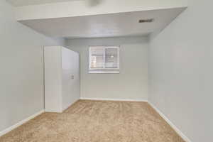 Unfurnished room featuring light colored carpet