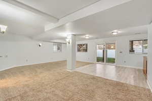 Basement featuring light hardwood / wood-style floors and a wealth of natural light