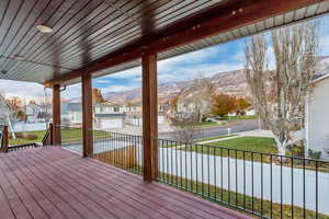 Wooden deck with a lawn and a mountain view