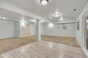 Basement featuring light hardwood / wood-style floors