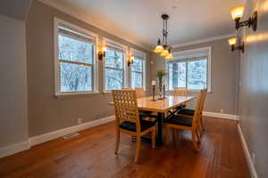 Dining area featuring hardwood / wood-style floors and ornamental molding