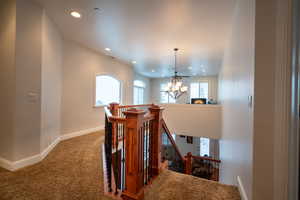 Staircase featuring carpet and an inviting chandelier