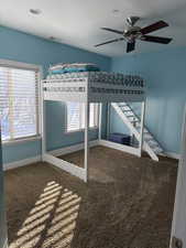 Unfurnished bedroom with carpet flooring and ceiling fan