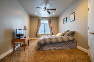 Bedroom featuring ceiling fan and carpet floors