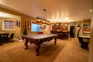 Game room featuring bar, light colored carpet, and pool table