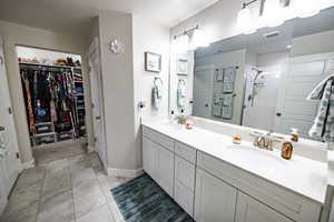 Bathroom with tile patterned floors, vanity, a shower, and a textured ceiling