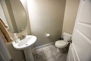 Bathroom featuring tile patterned floors and toilet