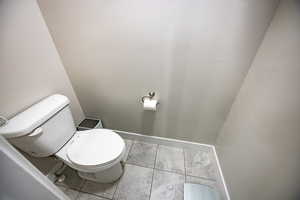 Bathroom featuring tile patterned flooring and toilet