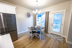 Dining space with an inviting chandelier and light wood-type flooring