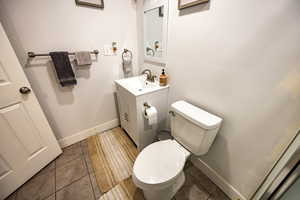 Bathroom with tile patterned floors, vanity, and toilet