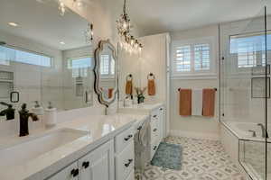 Bathroom with a wealth of natural light, vanity, and shower with separate bathtub