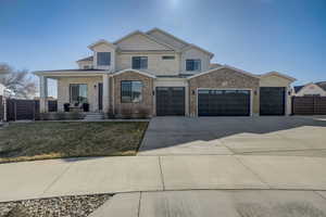 View of front facade featuring a front yard and a garage