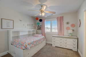 Bedroom featuring ceiling fan and light colored carpet