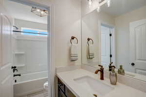 Full bathroom featuring shower / bathing tub combination, vanity, and toilet