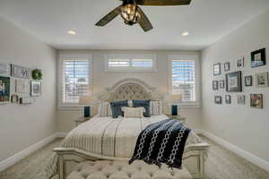 Carpeted bedroom with ceiling fan