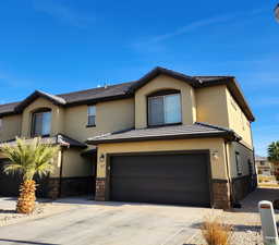 View of front facade featuring a garage