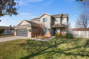 View of front property with a front yard and a garage